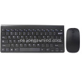Un teclado y un mouse inalámbricos negros para computadora portátil